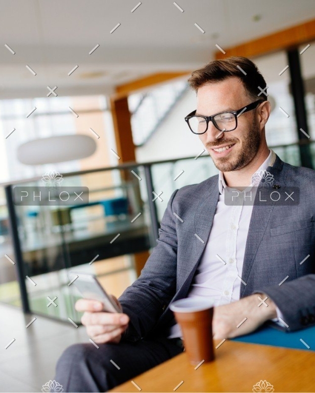 demo-attachment-437-businessman-taking-a-break-with-a-cup-of-coffee-JW4B3DH