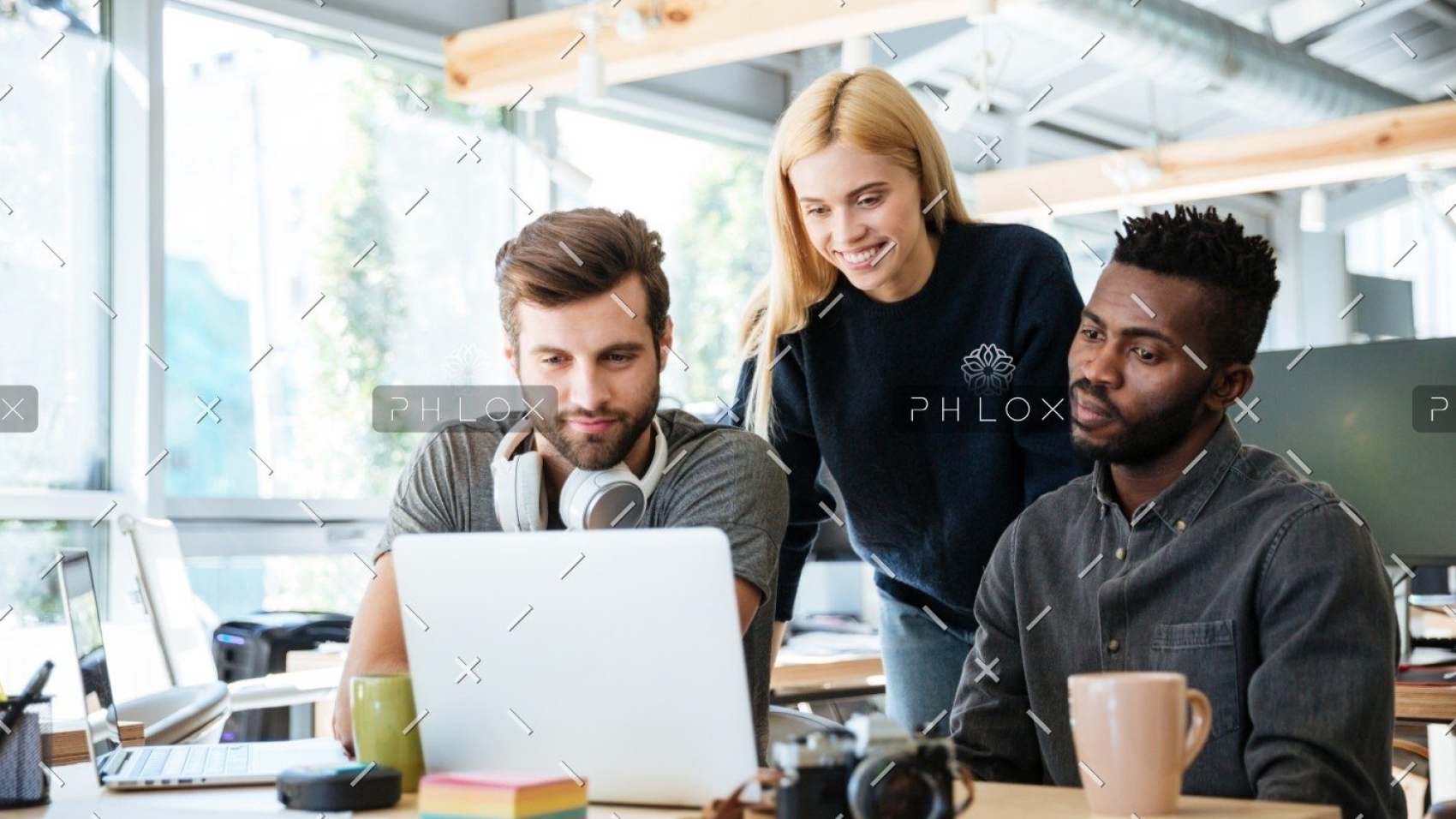 demo-attachment-447-happy-colleagues-sitting-in-office-coworking-PHYA6TG